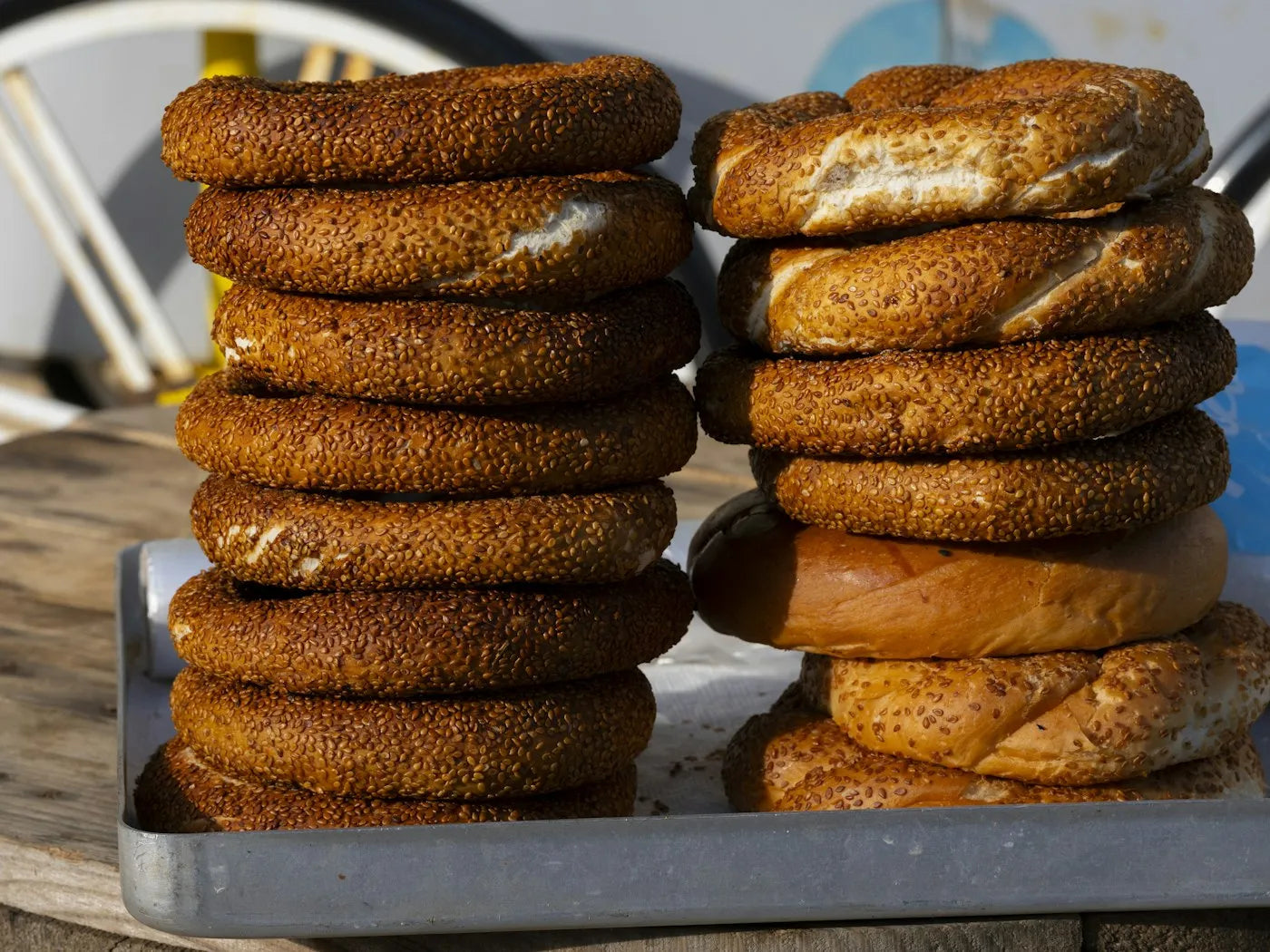 Stacks of sesame simit bread rings on a tray